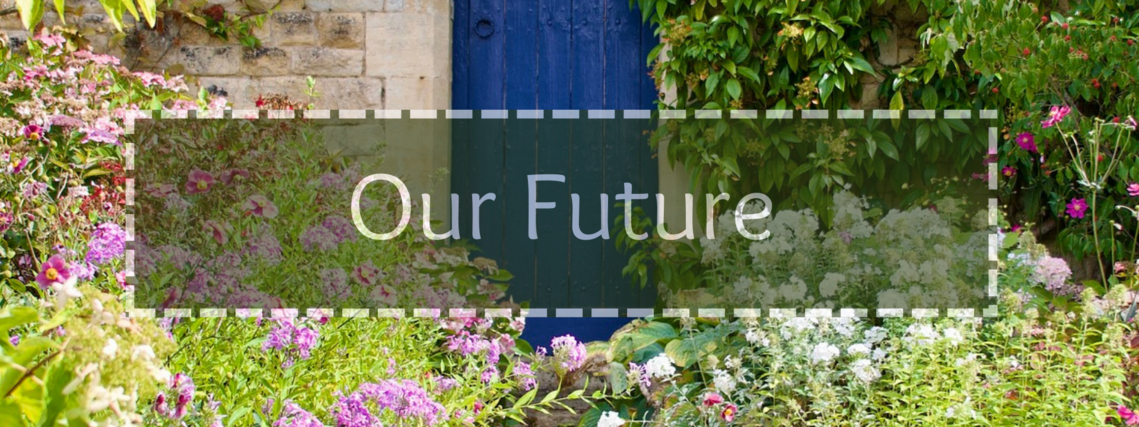 A blue garden door surrounded by blooming pink flowered shrubs